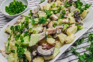 Potato salad with chicken and pickled mushrooms