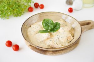 Chicken in cheese sauce in a pan