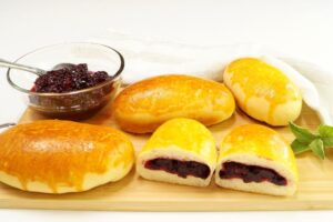 Yeast pies with jam in the oven