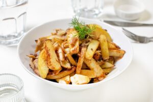 Fried potatoes with oyster mushrooms in a pan