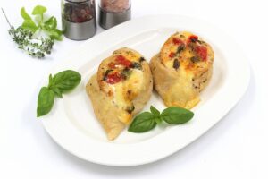 Chicken with cheese and tomatoes in the oven