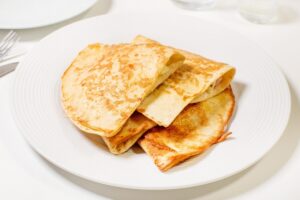 Lavash with sausage and cheese in a pan