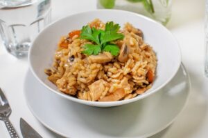 Rice with mushrooms and chicken in a pan