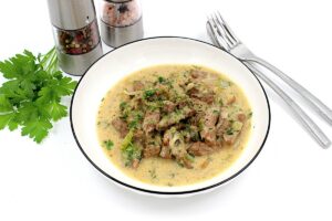 Befstroganov with sour cream in a pan