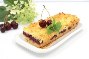 Sand pie with cherry in the oven