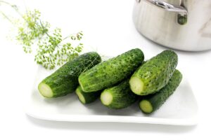 Loose cucumbers in a pot with garlic