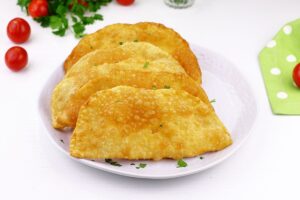 Pasties with cheese in a frying pan