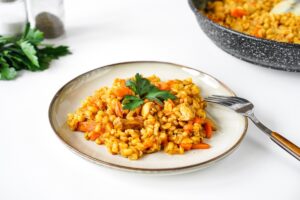 Barley with chicken in a frying pan