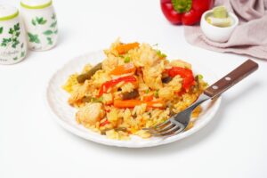 Rice with turkey and vegetables in a frying pan