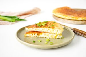 Cheese flatbread in a frying pan with cottage cheese