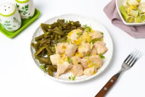 Chicken stewed in sour cream in a frying pan