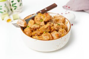 Pork in sour cream sauce in a frying pan